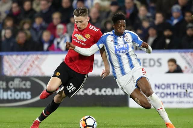 On the way back?: Huddersfield Town's Terence Kongolo, right.