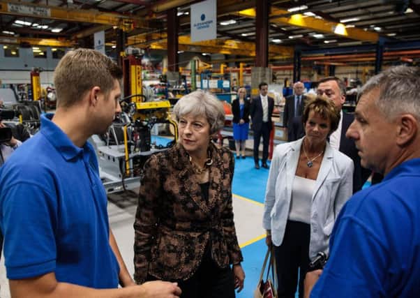 Theresa May on a recent factory minister with Skills Minister Anne Milton (second right) to promote new T Levels.