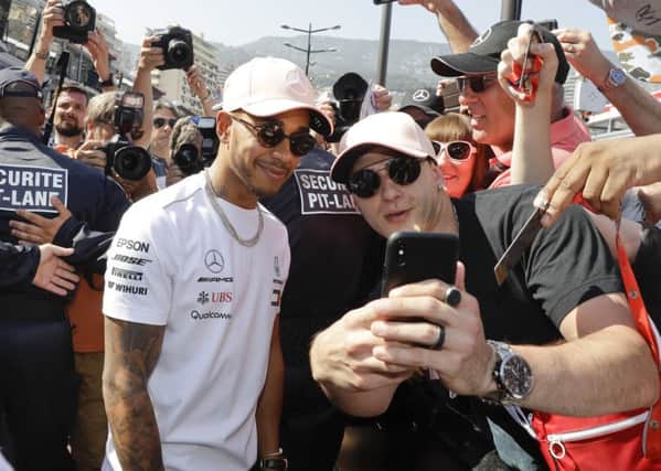 Lewis Hamilton poses with supporters.