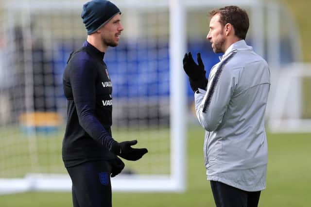 England's Jordan Henderson (left) and manager Gareth Southgate during a training session at St George's Park. Picture: Mike Egerton/PA