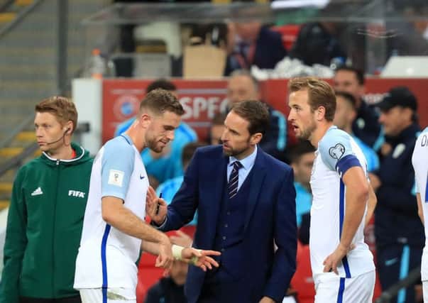 England manager Gareth Southgate (centre) talks to Jordan Henderson (left) and Harry Kane (right) in October last year. Picture: Mike Egerton/PA.