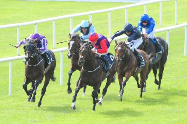 Romanised (centre) and jockey Shane Foley on the way to winning the Tattersalls Irish 2,000 Guineas at the Curragh. Picture: PA Wire