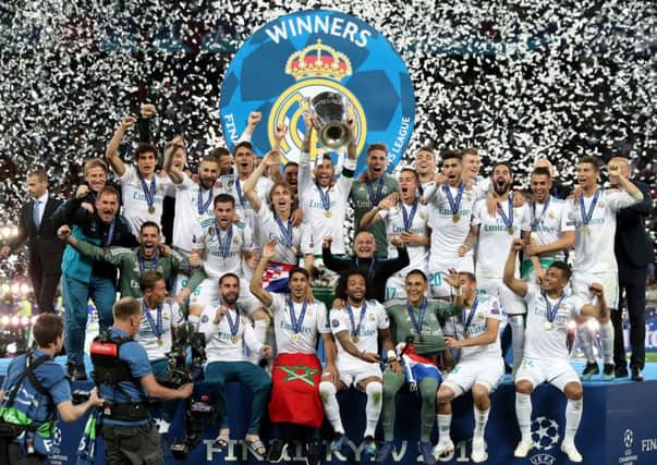 Champions: Real Madrid celebrate with the trophy.
