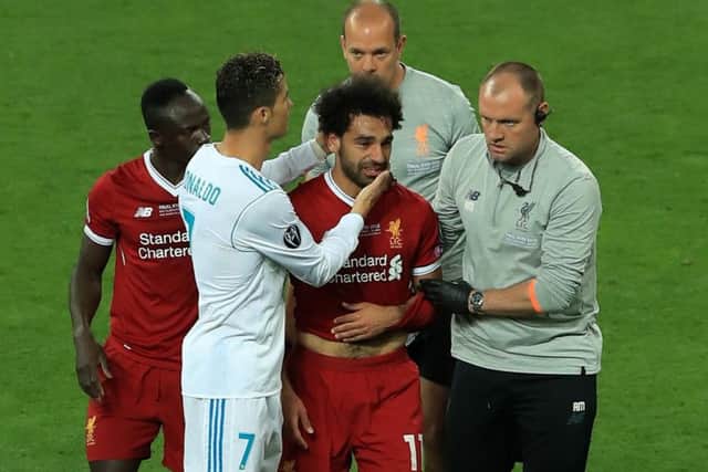 Exit: Real Madrid's Cristiano Ronaldo consoles Liverpool's Mohamed Salah as he leaves th pitch injured.