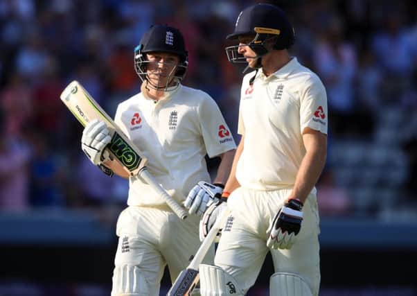 Standing firm: England's Dom Bees, left, and Jos Buttler walk off at the end of play.