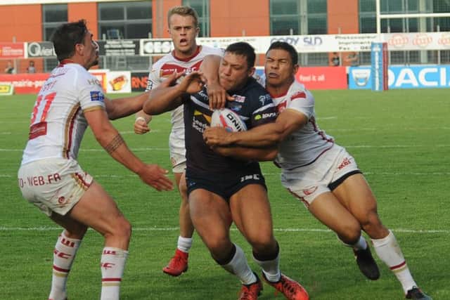 Halted: Rhinos wing Ryan Hall is stopped by the Dragons defence. Picture: Varleys.