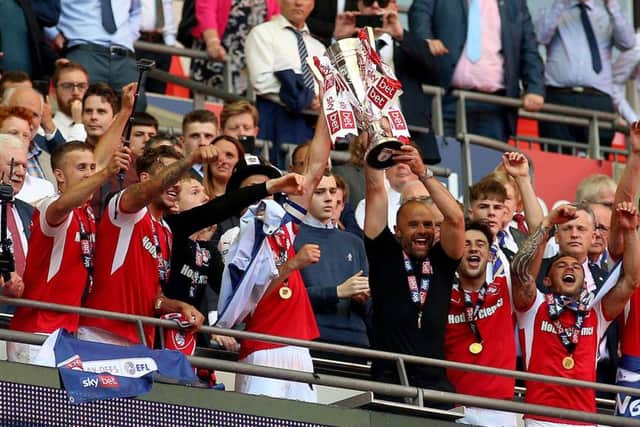 Rotherham United manager Paul Warne lifts the trophy with Richard Wood after winning the Sky Bet League One Final at Wembley Stadium, London. (Picture: Nigel French/PA Wire)