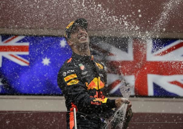 Red Bull driver Daniel Ricciardo celebrates on the podium