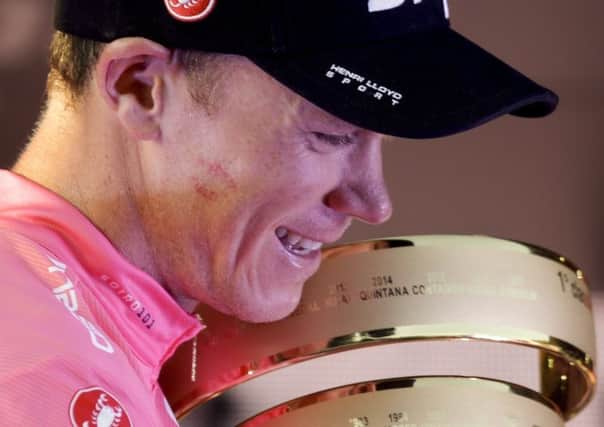Britain's Chris Froome holds the trophy of the Giro d'Italia cycling race, in Rome, Sunday. (AP Photo/Gregorio Borgia)