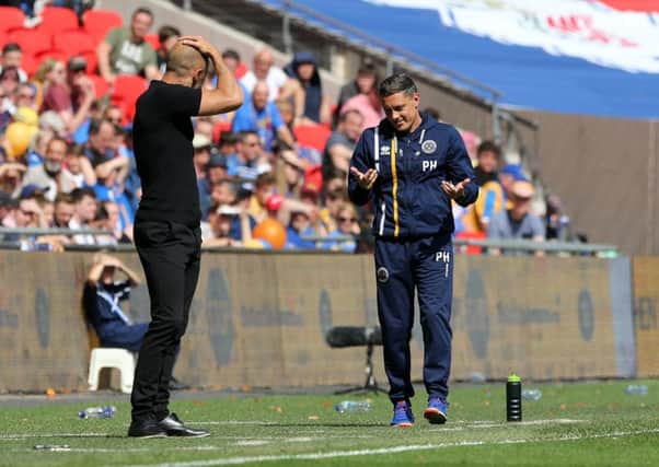 Shrewsbury Town manager Paul Hurst shrugging his shoulders towards Rotherham United manager Paul Warne from the touchline (Picture: John Patrick Fletcher/Action Plus via Getty Images)