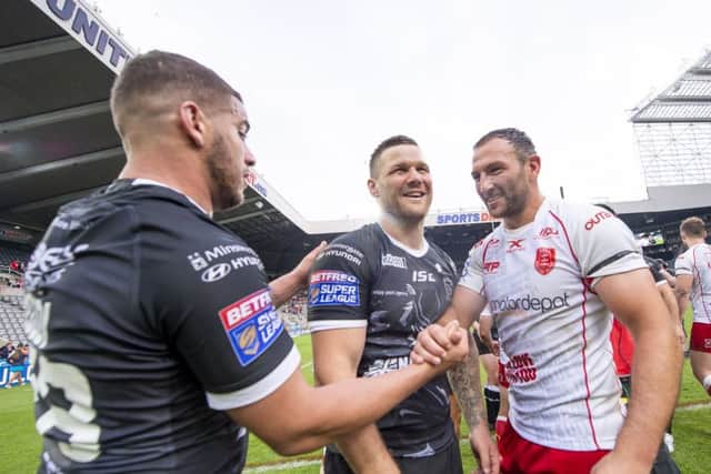 Hull FC's Hakim Miloudi and Kirk Yeaman shake hands with Hull KR's Tommy Lee.