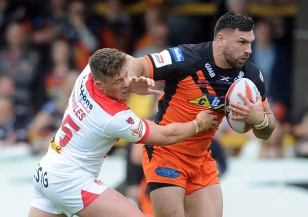 Palming off: Matt Cook, right, avoids the tackle by St Helens Morgan Knowles earlier this month in the first of two costly defeats by the Super League pacesetters. (Picture: Tony Johnson)
