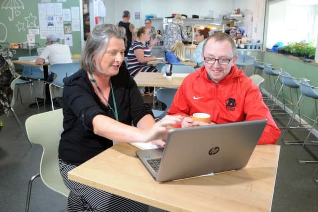Helen Murphy, community employment enterprise coach giving supported advice and guidance to find employment to client Paul Hayes-Hughes in the Community Shop in Athersley, Barnsley. Picture Tony Johnson.