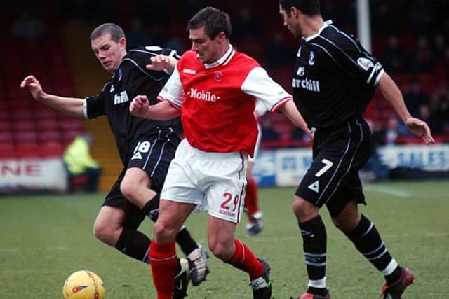 Rotherham player Richie Barker is squeezed out by defenders Hayden Mullins and Gary Borrowdale back in December 2002