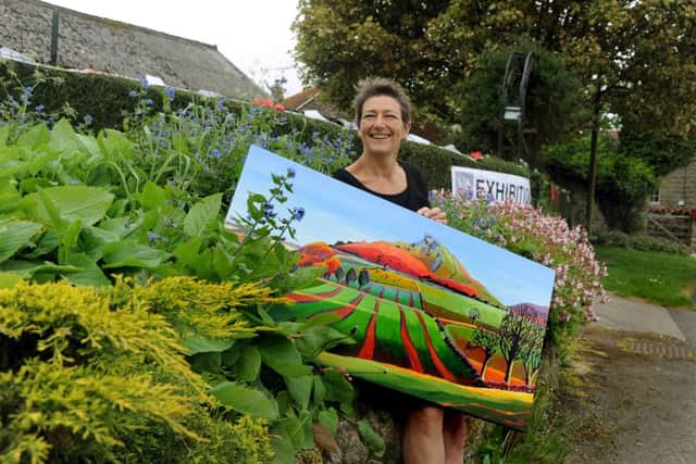 Artist Sue Slack with her landscape of Roseberry Topping exhibiting at Lockton, north of Pickering