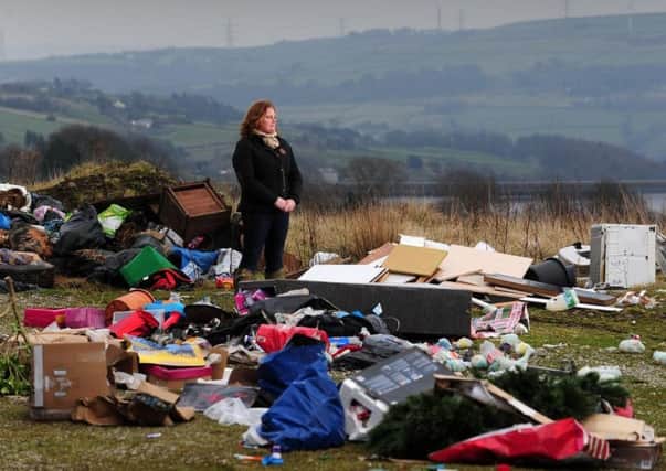 Rachel Hallos pictured amongst the mess left by flytippers alongside her farm in Ripponden.