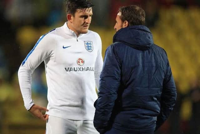 Harry Maguire speaking with England manager Gareth Southgate