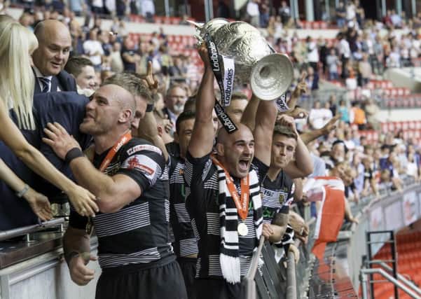 Hull FC's Danny Houghton jolds aloft the Ladbrokes Challenge Cup trophy as his side defeat Wigan.