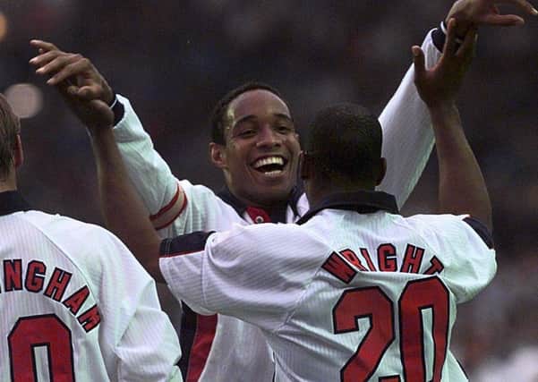 Joy: England's Ian Wright embraces teammate Paul Ince after scoring against Italy.