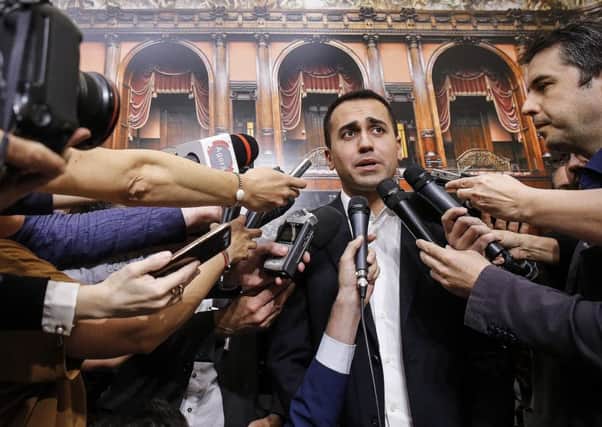 Five-Star Movement leader Luigi Di Maio meets reporters at the Italian parliament, in Rome, Wednesday, May 30, 2018. Italy will take more time to try to form a government rather than head for another election in order to avoid the risk of more financial market turmoil, the premier-designate said Wednesday. The two populist parties that got the most votes in the March 4 election failed to create a government over the weekend after President Sergio Mattarella vetoed their proposed economy minister. (Fabio Frustaci/ANSA via AP)